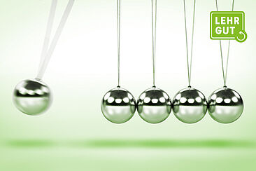 Nahaufnahme eines Newtonpendels in Bewegung