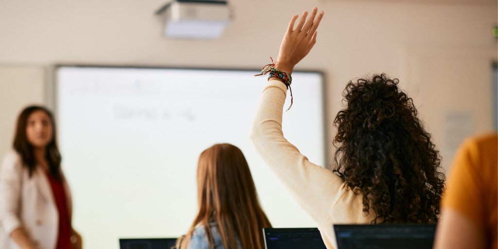 Professorin in einem Seminar, eine Studentin meldet sich © iStock.com - Drazen Zigic