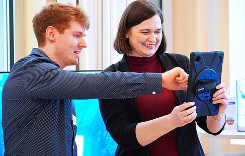 Zwei Personen mit einem Tablet in der Hand