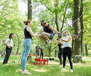 Participants in a start-up workshop on a slackline