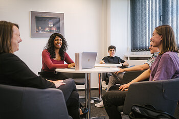 Professorin mit vier Studierenden bei einer Besprechung