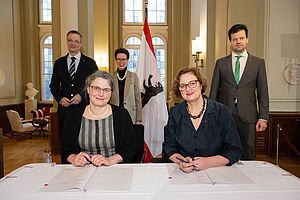 Prof. Dr. Annabella Rauscher-Scheibe und Dr. Ina Czyborra bei der Unterzeichnung des Hochschulvertrags. Im Hintergrund Prof. Dr. Tilo Wendler, Prof. Dr. Stefanie Molthagen-Schnöring und Dr. Henry Marx.