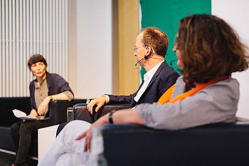 Professors discussing on a podium