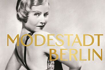 Schwarz-weiß Fotografie von Lilian Harvey in einem schwarzen Abendkleid, darüber der Schriftzug Modestadt Berlin