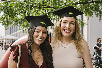 Two graduates with graduate hats